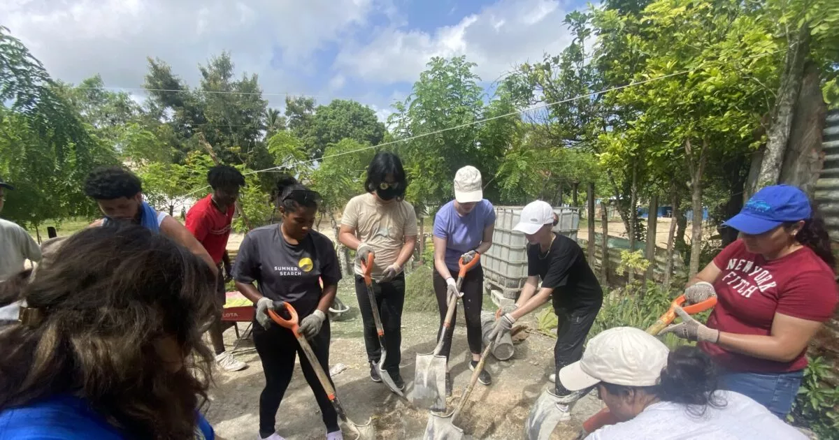 Community volunteers working together on the ground during a CSR programme.